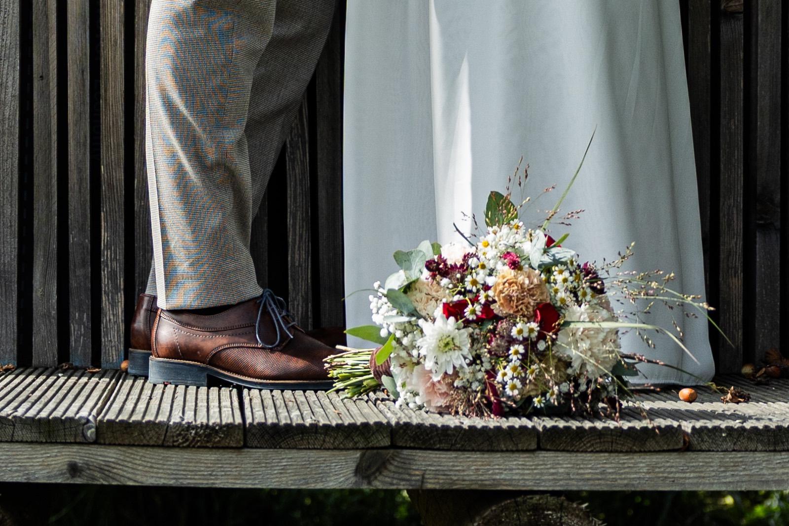 Brautschuhe und Blumenstrauß auf Holzstufen